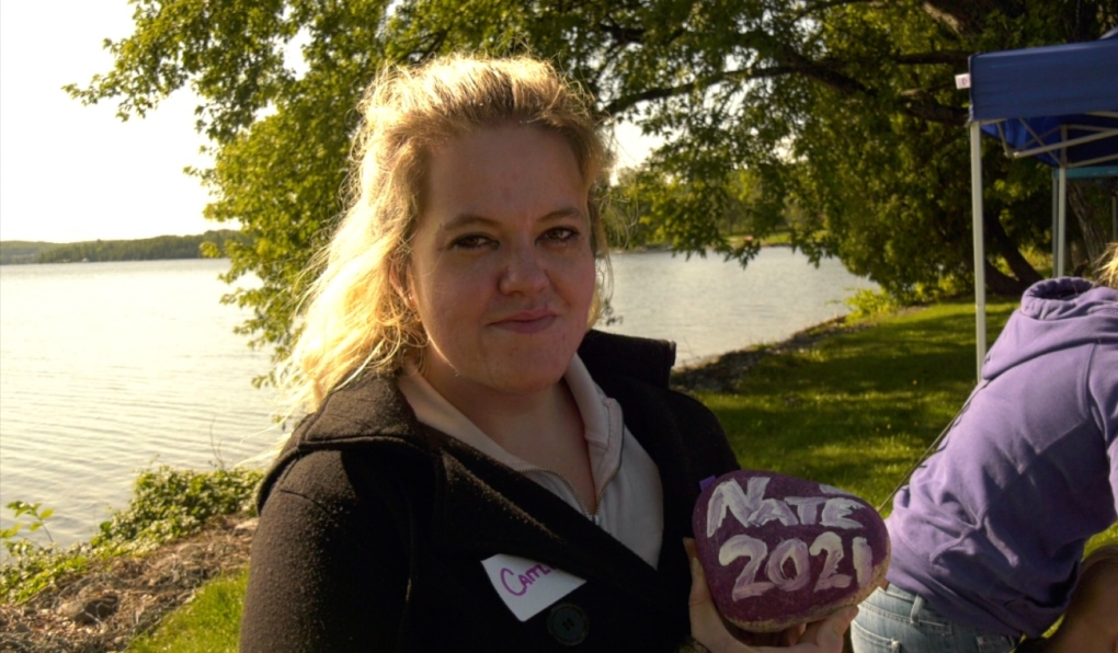 PWLE Committee member Caitlin holding the stone she painted in memory of her dear friend.